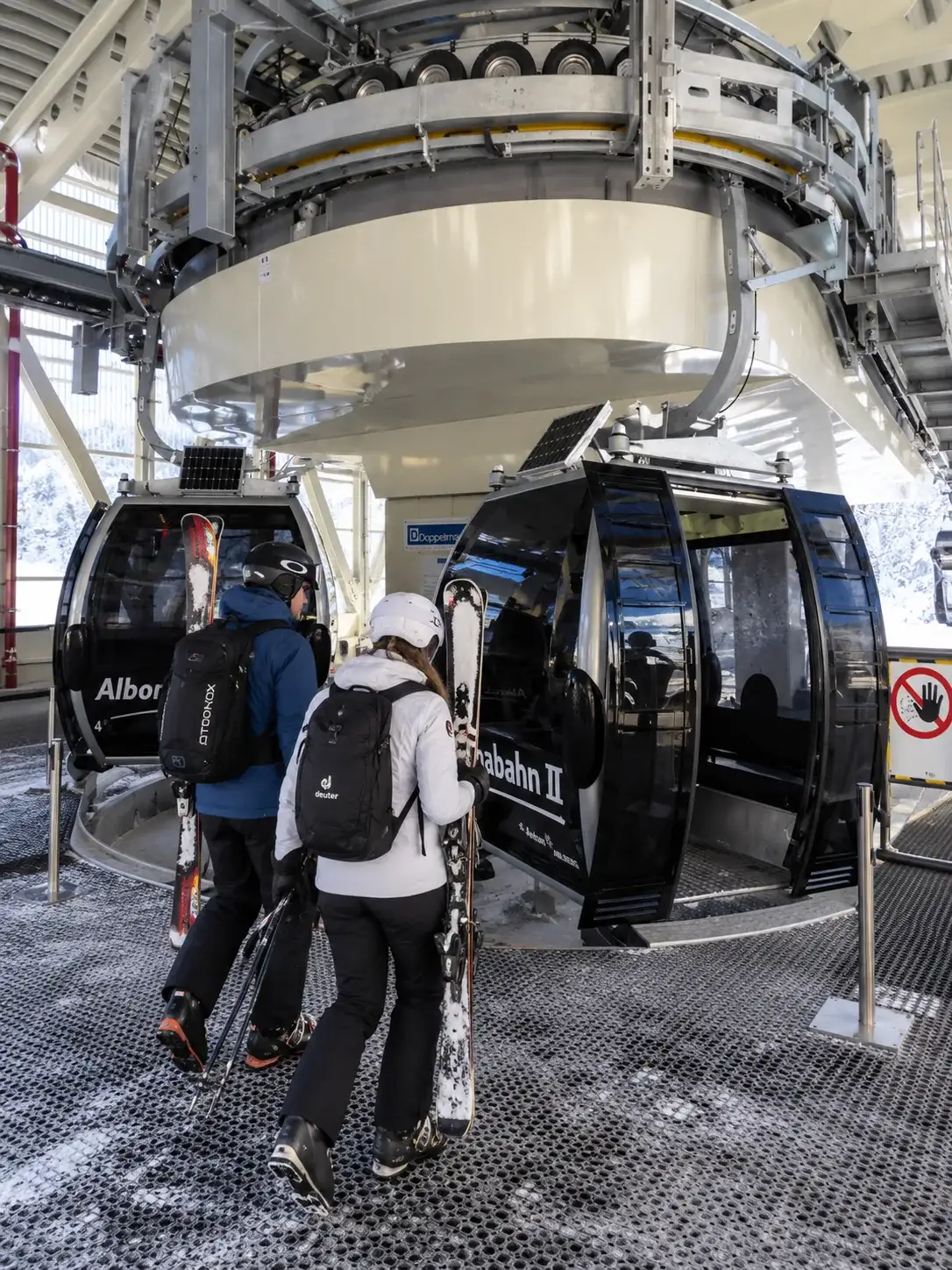 Skiing in Stuben am Arlberg and on the Albona Skiers boarding the Albonabahn II gondola above Stuben am Arlberg