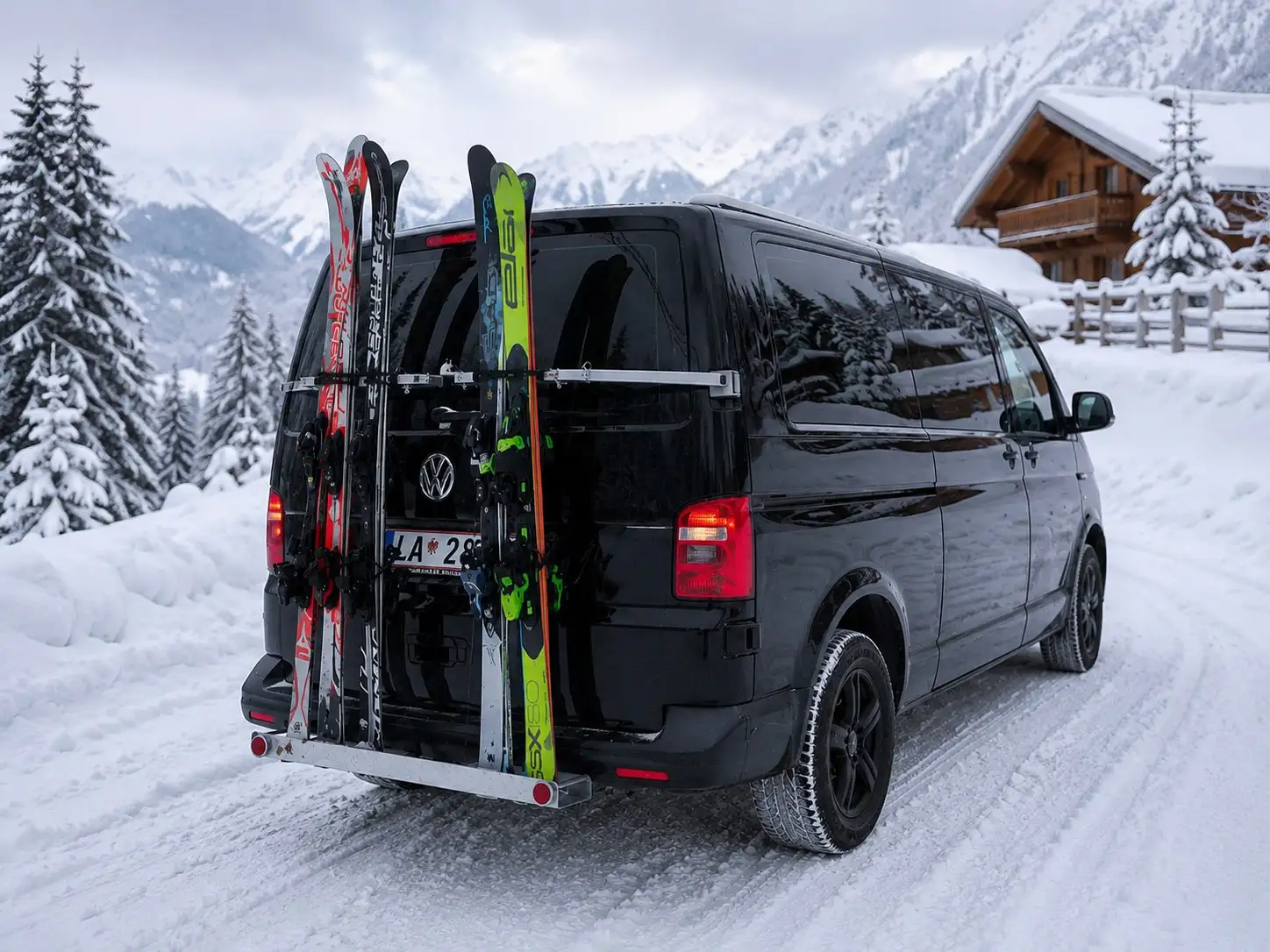Alpinum Taxi skis loaded on the rear rack of a transfer vehicle