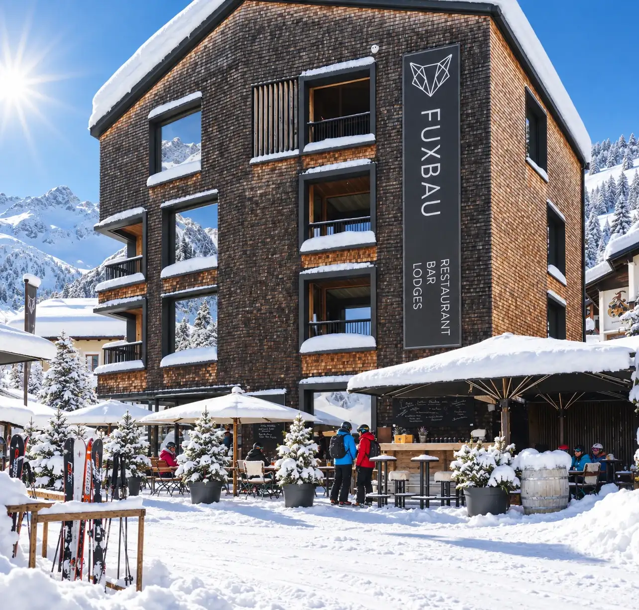 Après-Ski and Winter Activities in Stuben am Arlberg The Fuxbau in Stuben am Arlberg with its umbrella bar and skis stacked outside on a winter day